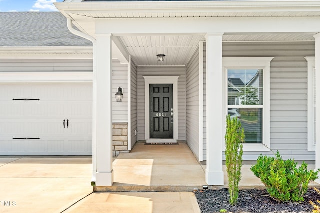 6531 Knob Creek Dr, Whitsett, NC 27377 - view of exterior entry with an attached garage and driveway