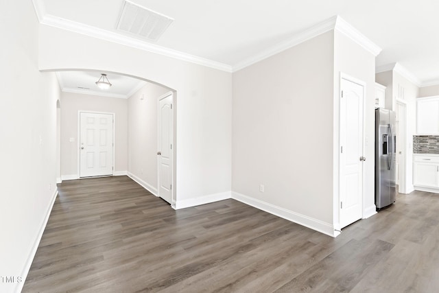6531 Knob Creek Dr, Whitsett, NC 27377 - unfurnished room with arched walkways, wood finished floors, and crown molding