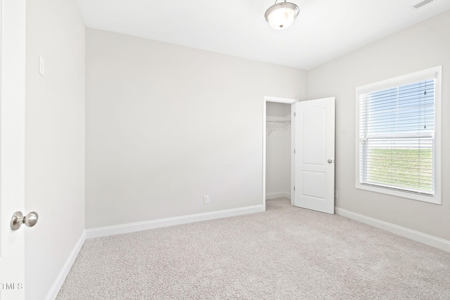 6531 Knob Creek Dr, Whitsett, NC 27377 - unfurnished bedroom with carpet flooring and a walk in closet