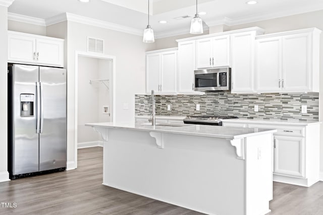 6531 Knob Creek Dr, Whitsett, NC 27377 - kitchen with appliances with stainless steel finishes, recessed lighting, white cabinetry, crown molding, and decorative backsplash