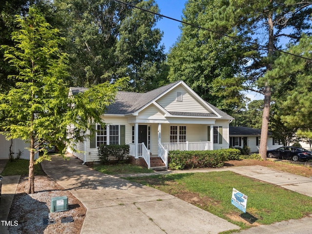 305 Justice Heights St, Apex, NC 27502 - view of front facade with a porch, concrete driveway, roof with shingles, and a front lawn