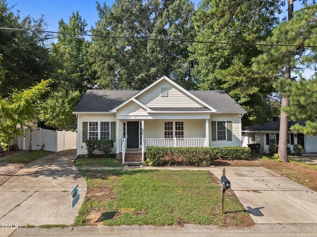 305 Justice Heights St, Apex, NC 27502 - bungalow-style home featuring a porch, roof with shingles, and driveway