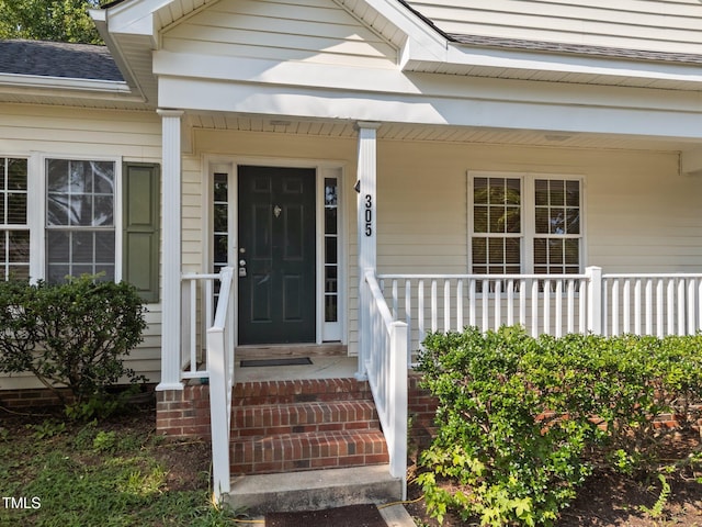 305 Justice Heights St, Apex, NC 27502 - view of exterior entry with roof with shingles and covered porch