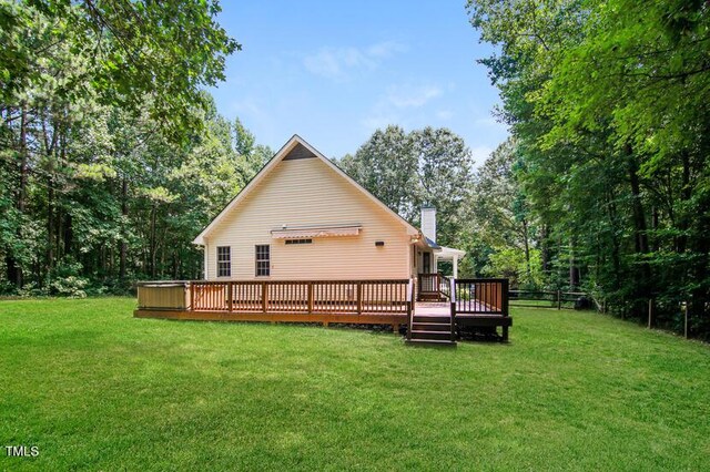 190 Hardwood Dr, Franklinton, NC 27525 - back of house featuring a chimney, a lawn, and a wooden deck