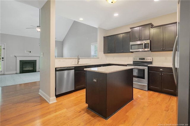 1234 Micahs Way N, Spring Lake, NC 28390 - kitchen featuring stainless steel appliances, a kitchen island, light countertops, tasteful backsplash, and recessed lighting