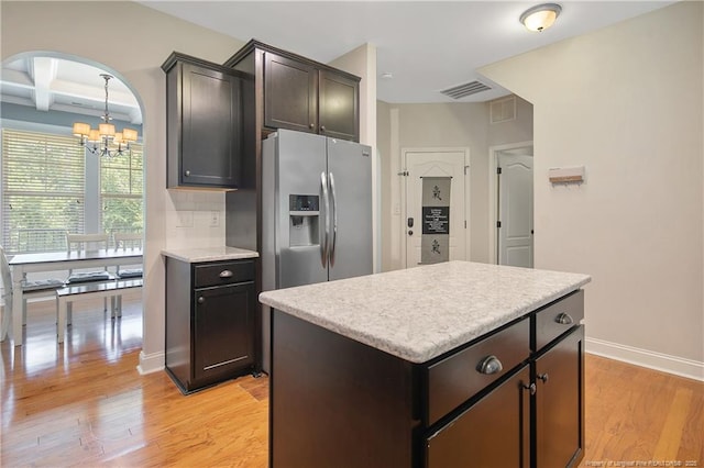 1234 Micahs Way N, Spring Lake, NC 28390 - kitchen with stainless steel refrigerator with ice dispenser, a chandelier, light countertops, light wood-style floors, and arched walkways