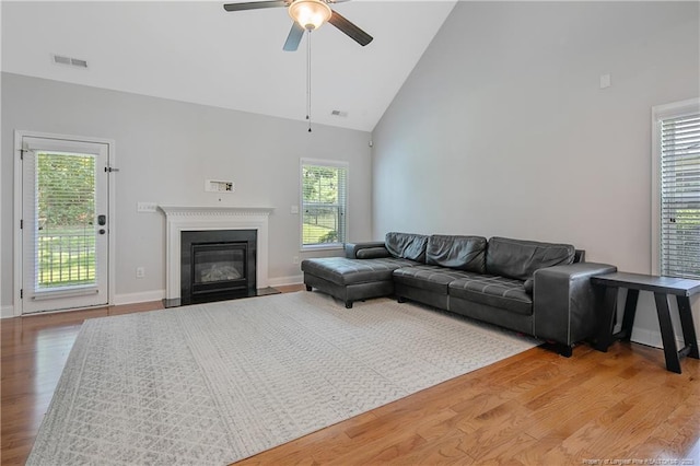 1234 Micahs Way N, Spring Lake, NC 28390 - living area with high vaulted ceiling, ceiling fan, light wood-style flooring, and a fireplace with flush hearth