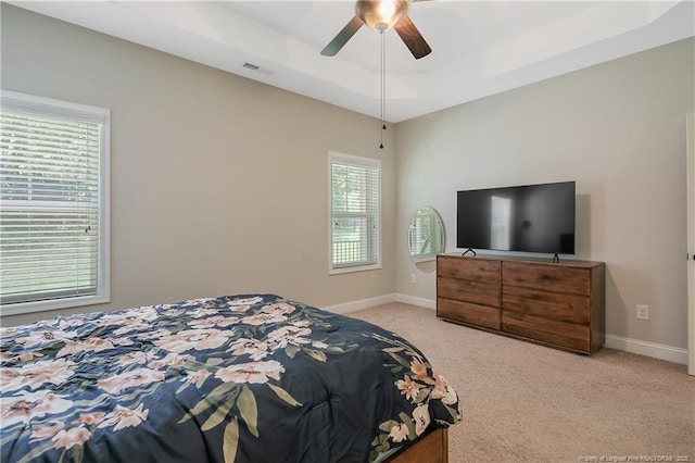 1234 Micahs Way N, Spring Lake, NC 28390 - bedroom with a tray ceiling, light colored carpet, and ceiling fan