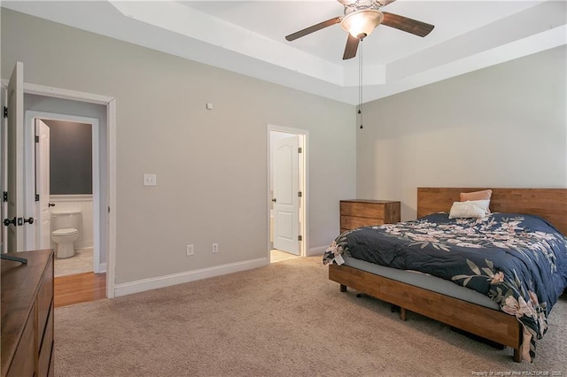 1234 Micahs Way N, Spring Lake, NC 28390 - bedroom featuring light carpet, ensuite bath, a raised ceiling, and a ceiling fan