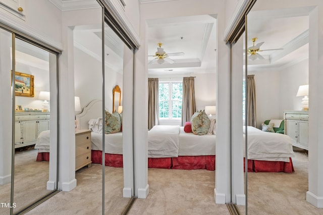 116 Northbrook Dr Unit 303, Raleigh, NC 27609 - bedroom with light colored carpet, ornamental molding, a tray ceiling, and ceiling fan