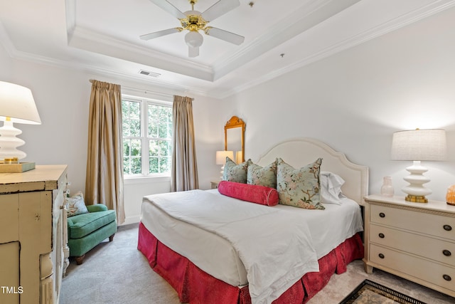 116 Northbrook Dr Unit 303, Raleigh, NC 27609 - bedroom with light colored carpet, crown molding, a tray ceiling, and ceiling fan