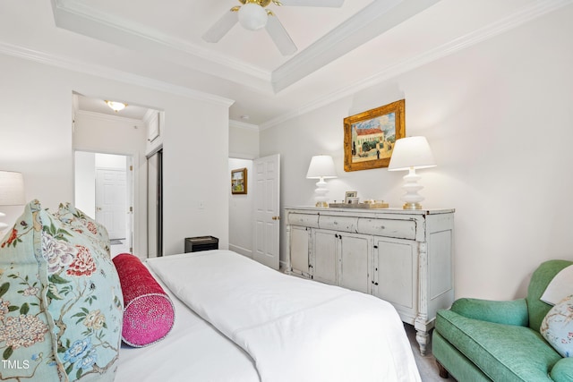 116 Northbrook Dr Unit 303, Raleigh, NC 27609 - bedroom with ornamental molding, a tray ceiling, a ceiling fan, and a closet