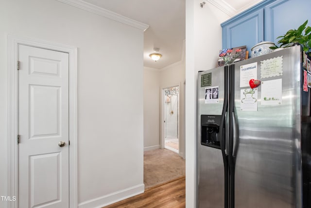 116 Northbrook Dr Unit 303, Raleigh, NC 27609 - kitchen featuring stainless steel fridge, blue cabinets, wood finished floors, and ornamental molding