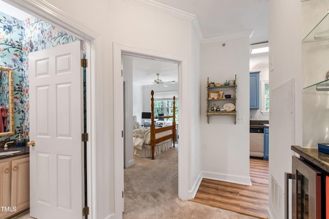 116 Northbrook Dr Unit 303, Raleigh, NC 27609 - corridor with beverage cooler, crown molding, and light colored carpet