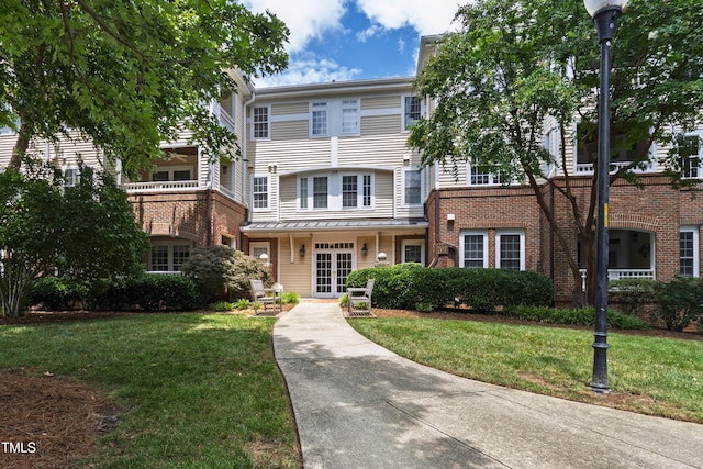 116 Northbrook Dr Unit 303, Raleigh, NC 27609 - view of front facade with a front lawn, french doors, and brick siding