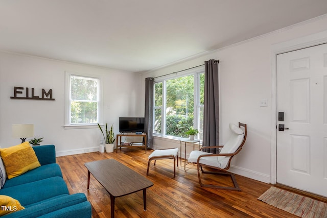 2331 Stevens Rd, Raleigh, NC 27610 - living area with healthy amount of natural light, wood finished floors, and crown molding