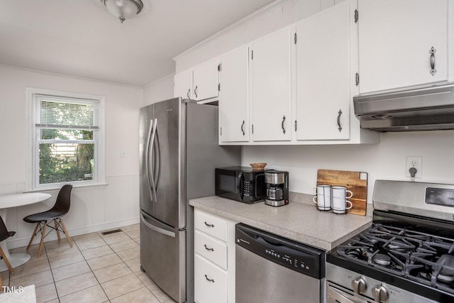 2331 Stevens Rd, Raleigh, NC 27610 - kitchen with appliances with stainless steel finishes, light countertops, white cabinets, under cabinet range hood, and light tile patterned floors