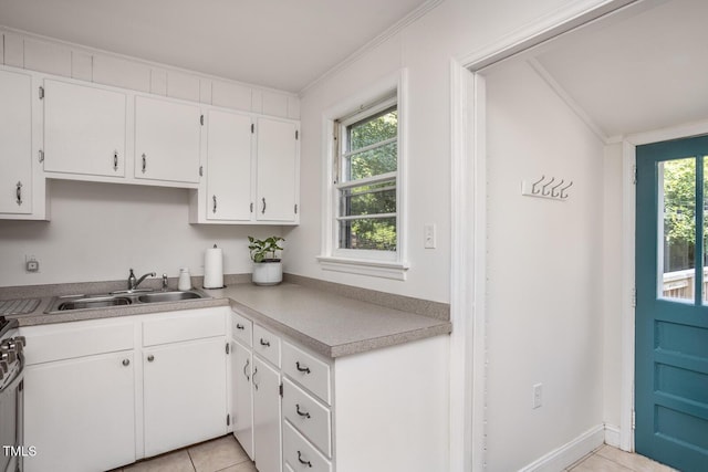2331 Stevens Rd, Raleigh, NC 27610 - kitchen featuring white cabinetry, light tile patterned flooring, light countertops, ornamental molding, and gas range