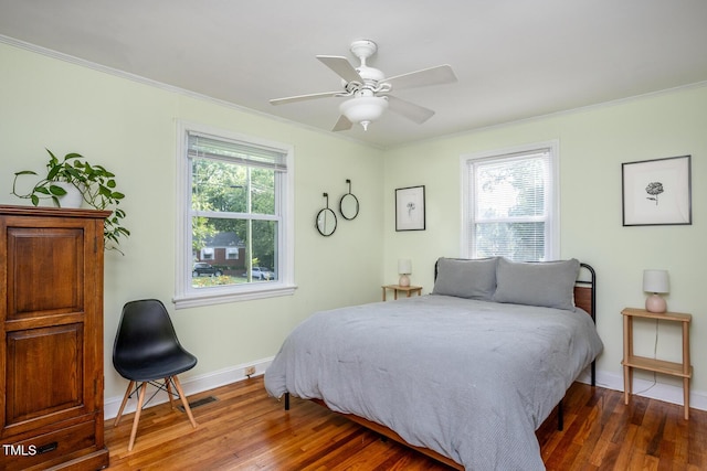 2331 Stevens Rd, Raleigh, NC 27610 - bedroom with multiple windows, wood finished floors, crown molding, and ceiling fan
