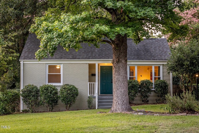 2331 Stevens Rd, Raleigh, NC 27610 - view of front of house with roof with shingles, a front lawn, and brick siding