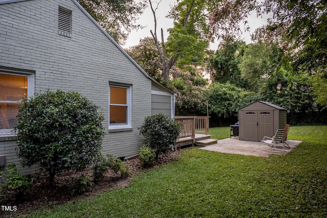 2331 Stevens Rd, Raleigh, NC 27610 - view of green lawn featuring a storage unit, a patio area, and a wooden deck