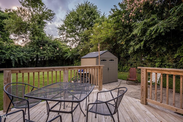 2331 Stevens Rd, Raleigh, NC 27610 - wooden terrace featuring outdoor dining space, a storage unit, a yard, and view of scattered trees