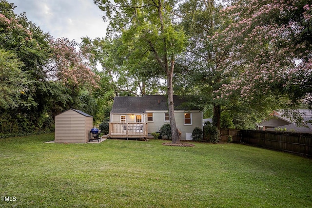 2331 Stevens Rd, Raleigh, NC 27610 - back of house with a storage shed, a deck, and view of wooded area