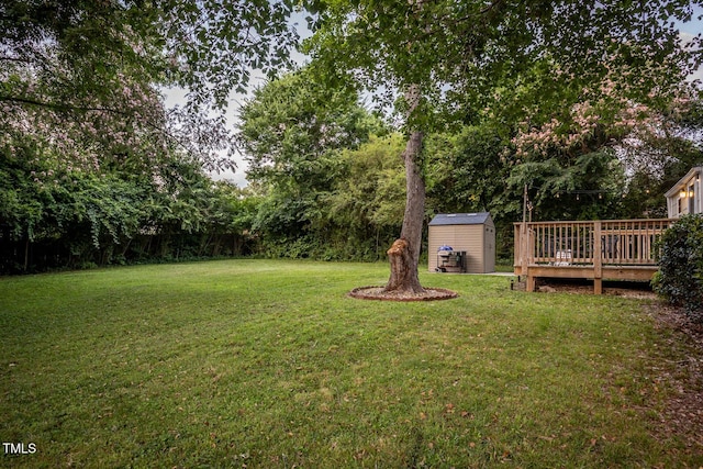 2331 Stevens Rd, Raleigh, NC 27610 - view of grassy yard featuring a storage unit and a deck