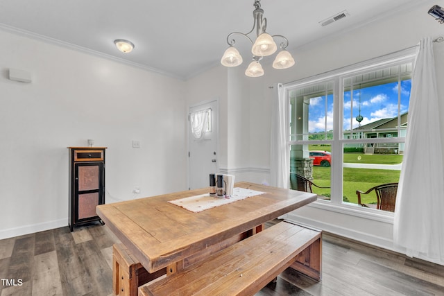 450 Cotton Mill Dr, Zebulon, NC 27597 - dining area with crown molding, a chandelier, and dark wood-style floors