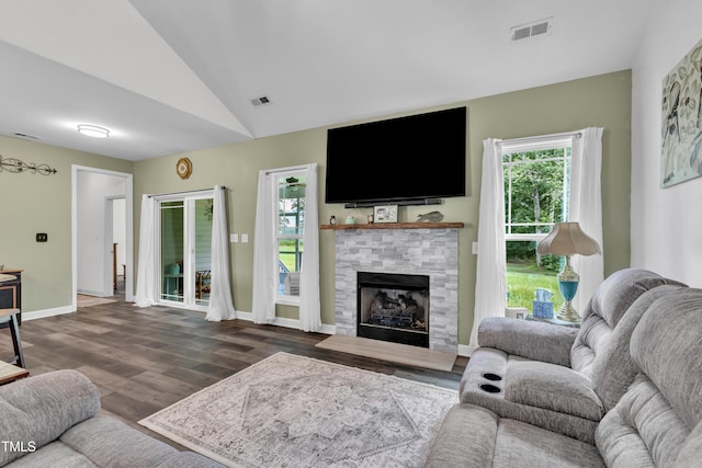 450 Cotton Mill Dr, Zebulon, NC 27597 - living room featuring dark wood-style floors, a tile fireplace, and vaulted ceiling