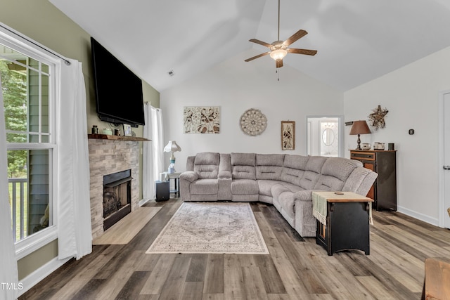 450 Cotton Mill Dr, Zebulon, NC 27597 - living area with ceiling fan, a stone fireplace, high vaulted ceiling, and wood finished floors