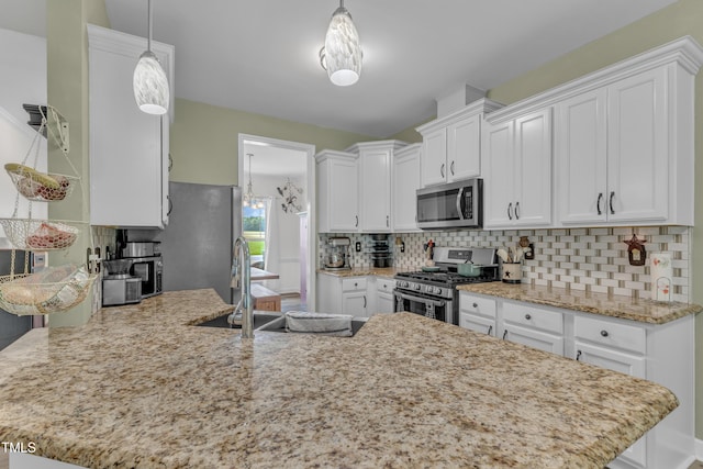 450 Cotton Mill Dr, Zebulon, NC 27597 - kitchen with stainless steel appliances, a peninsula, and white cabinets