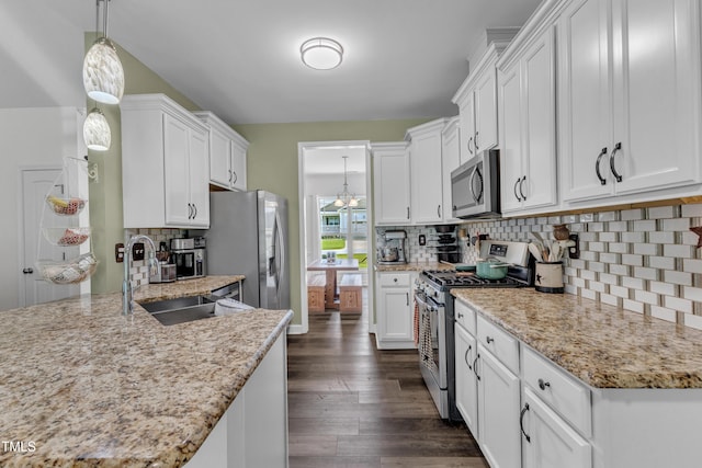 450 Cotton Mill Dr, Zebulon, NC 27597 - kitchen with appliances with stainless steel finishes, dark wood-style flooring, white cabinets, and backsplash