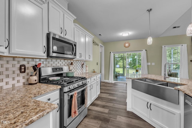 450 Cotton Mill Dr, Zebulon, NC 27597 - kitchen featuring appliances with stainless steel finishes, white cabinets, decorative backsplash, and dark wood-style floors