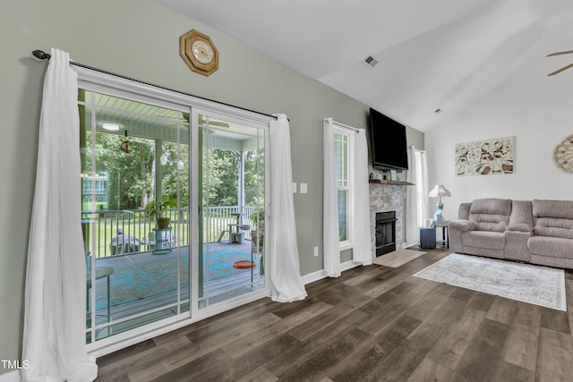450 Cotton Mill Dr, Zebulon, NC 27597 - living area featuring vaulted ceiling, dark wood finished floors, a ceiling fan, and a fireplace with flush hearth