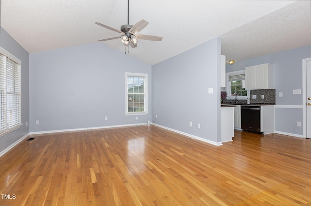 637 Convexa Ct, Wendell, NC 27591 - unfurnished living room with a ceiling fan, light wood finished floors, healthy amount of natural light, and vaulted ceiling