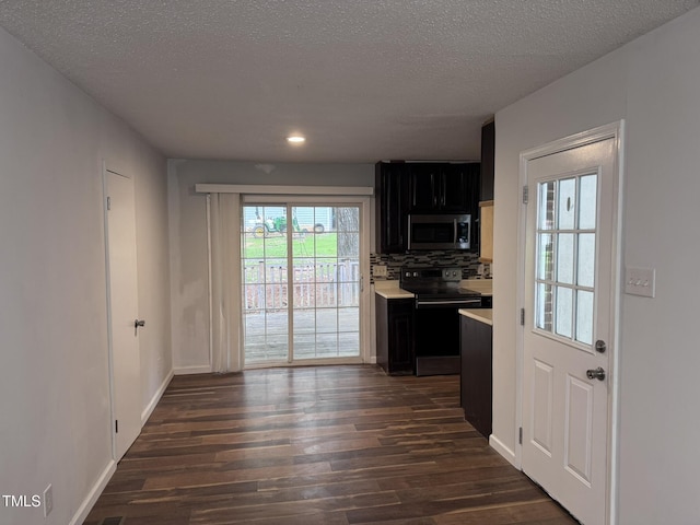 6740 Guess Rd, Hillsborough, NC 27278 - kitchen with stainless steel microwave, electric range oven, dark cabinets, light countertops, and dark wood finished floors