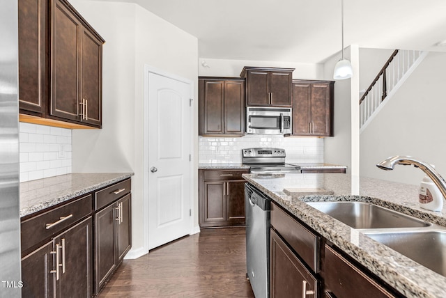 7817 Elmshire Way, Raleigh, NC 27616 - kitchen with appliances with stainless steel finishes, tasteful backsplash, dark wood-style floors, and dark brown cabinets