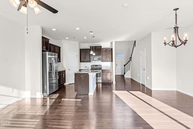 7817 Elmshire Way, Raleigh, NC 27616 - kitchen featuring stainless steel appliances, dark brown cabinetry, dark wood finished floors, tasteful backsplash, and recessed lighting