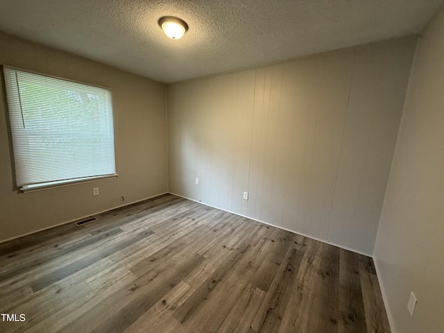 306 N Discovery St Unit A, B, C, D, Rocky Mount, NC 27801 - unfurnished room featuring wood finished floors, a textured ceiling, and healthy amount of natural light