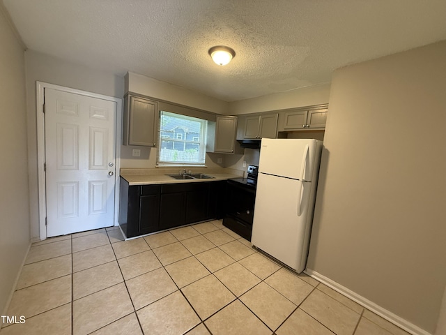 306 N Discovery St Unit A, B, C, D, Rocky Mount, NC 27801 - kitchen featuring freestanding refrigerator, black electric range oven, light countertops, a textured ceiling, and light tile patterned floors