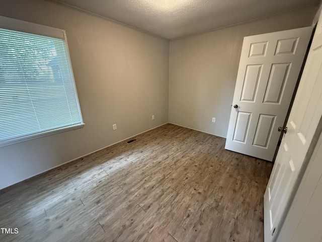 306 N Discovery St Unit A, B, C, D, Rocky Mount, NC 27801 - unfurnished room featuring wood finished floors, plenty of natural light, and a textured ceiling