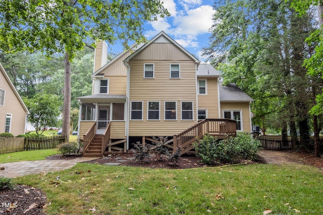 3 Fieldcrest Ct, Durham, NC 27713 - back of property with stairway, a sunroom, a chimney, and a deck