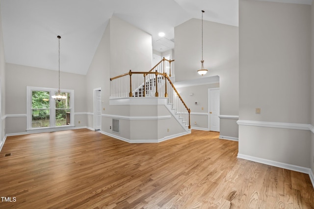 3 Fieldcrest Ct, Durham, NC 27713 - unfurnished living room featuring high vaulted ceiling, a chandelier, stairs, and light wood finished floors