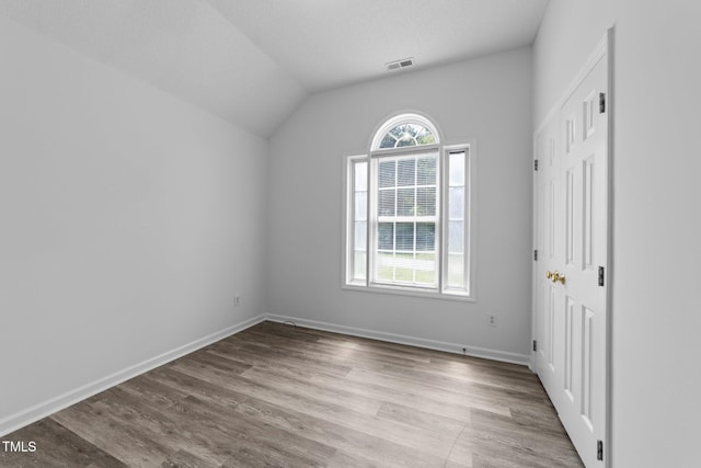 4812 Morecambe Way, Apex, NC 27539 - unfurnished bedroom with wood finished floors and lofted ceiling