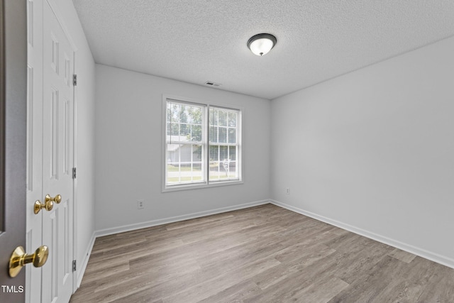 4812 Morecambe Way, Apex, NC 27539 - unfurnished bedroom with a textured ceiling and wood finished floors