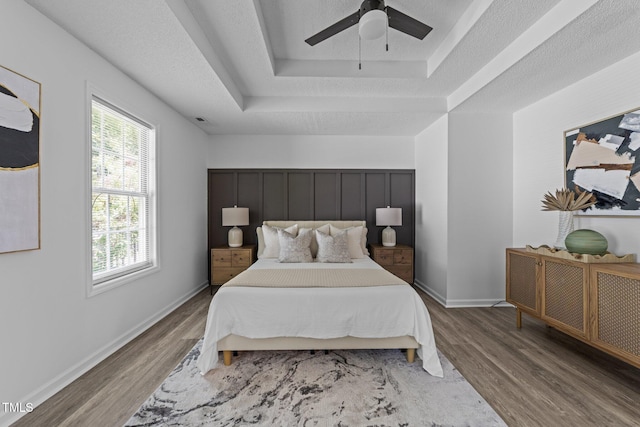 4812 Morecambe Way, Apex, NC 27539 - bedroom with wood finished floors, a raised ceiling, and ceiling fan