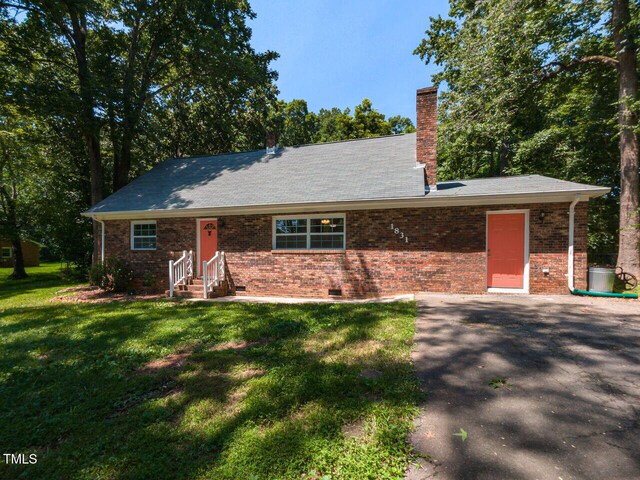 1831 Washington Dr, Hillsborough, NC 27278 - view of front of property featuring a front yard, entry steps, a chimney, brick siding, and crawl space