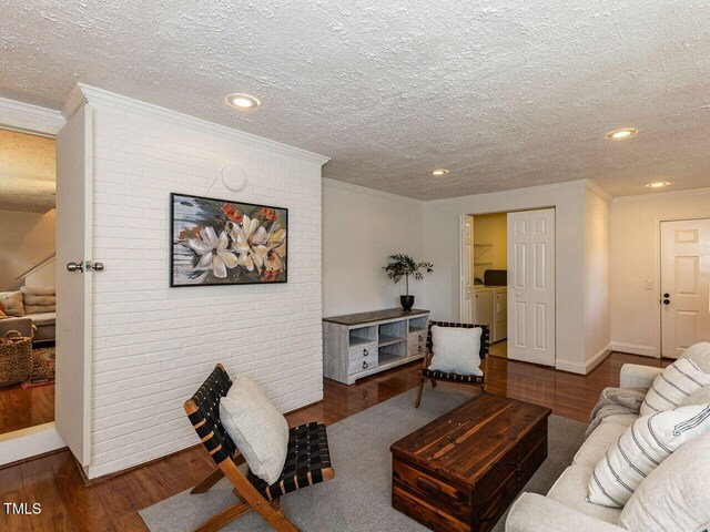 1831 Washington Dr, Hillsborough, NC 27278 - living room featuring ornamental molding, washer and dryer, wood finished floors, a textured ceiling, and stairs