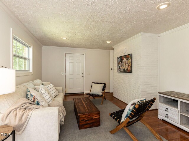 1831 Washington Dr, Hillsborough, NC 27278 - living room with a textured ceiling, ornamental molding, wood finished floors, and recessed lighting